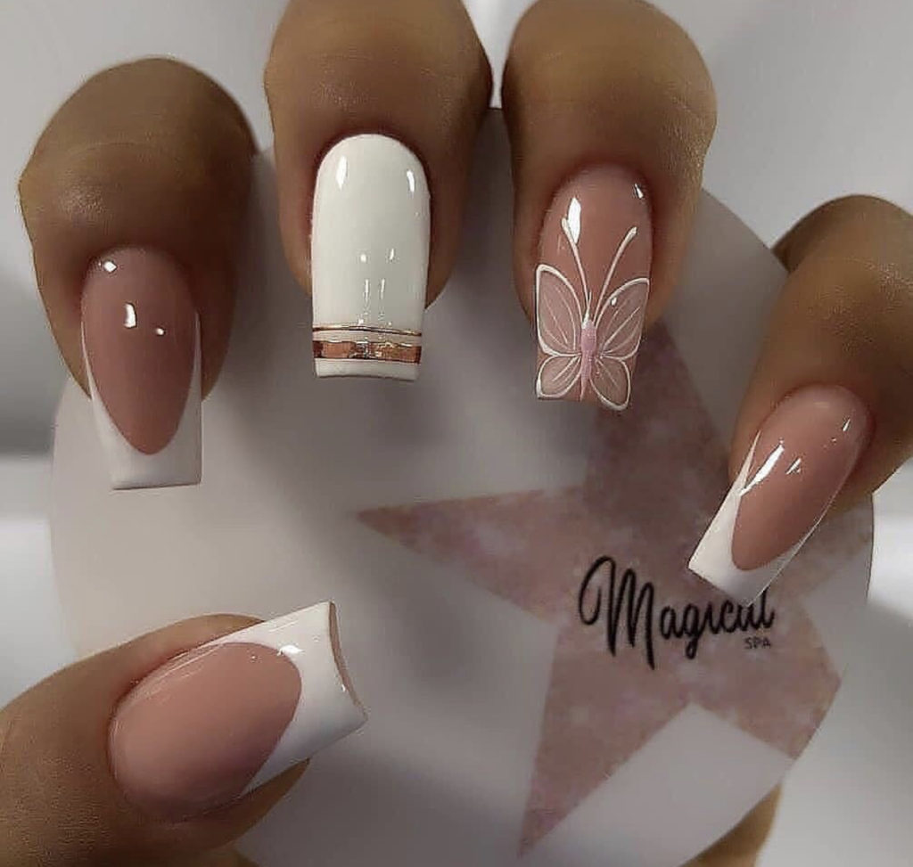 2. Medium nude and white butterfly coffin nails.