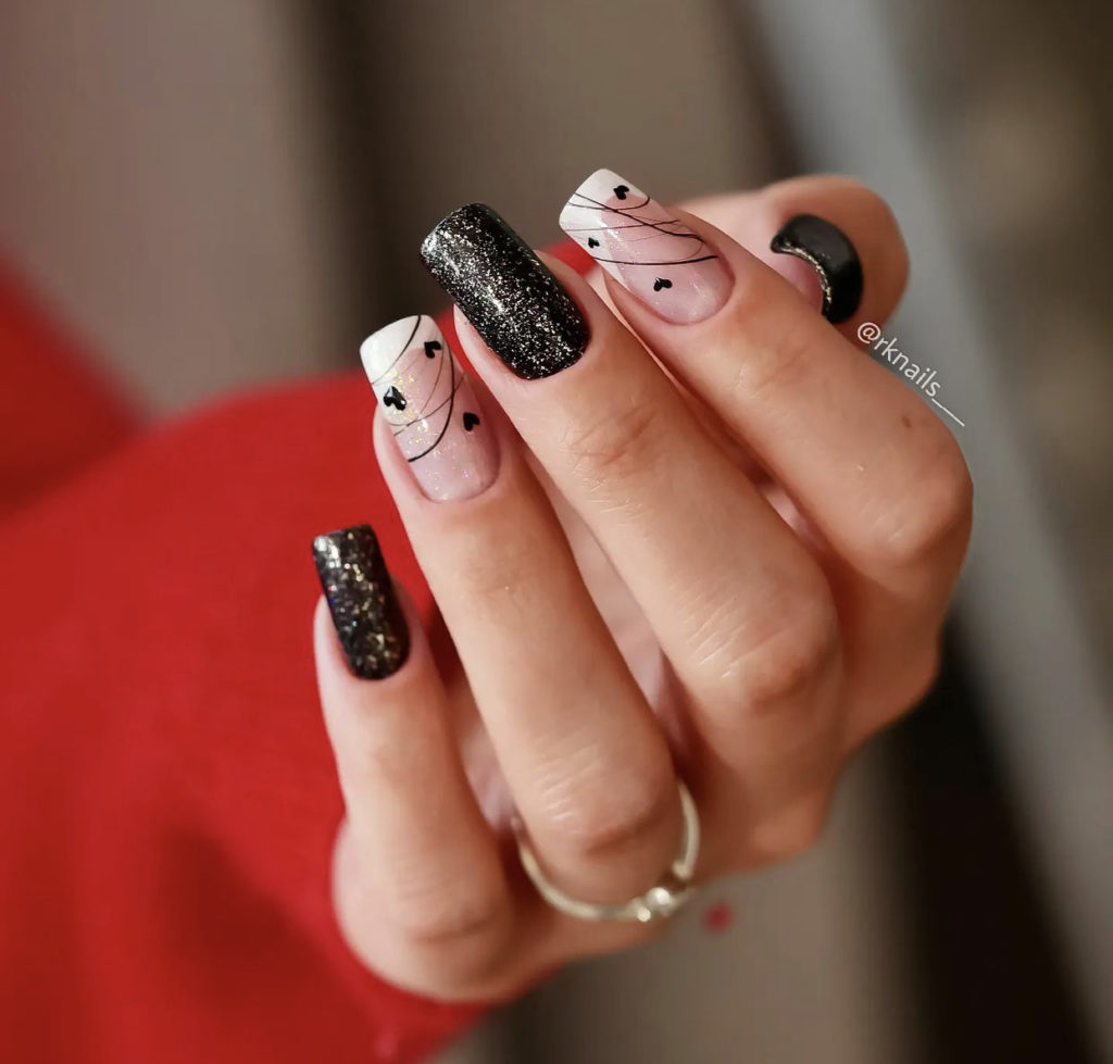 8. Black And Nude Coffin Nails With Hearts And Sparkles