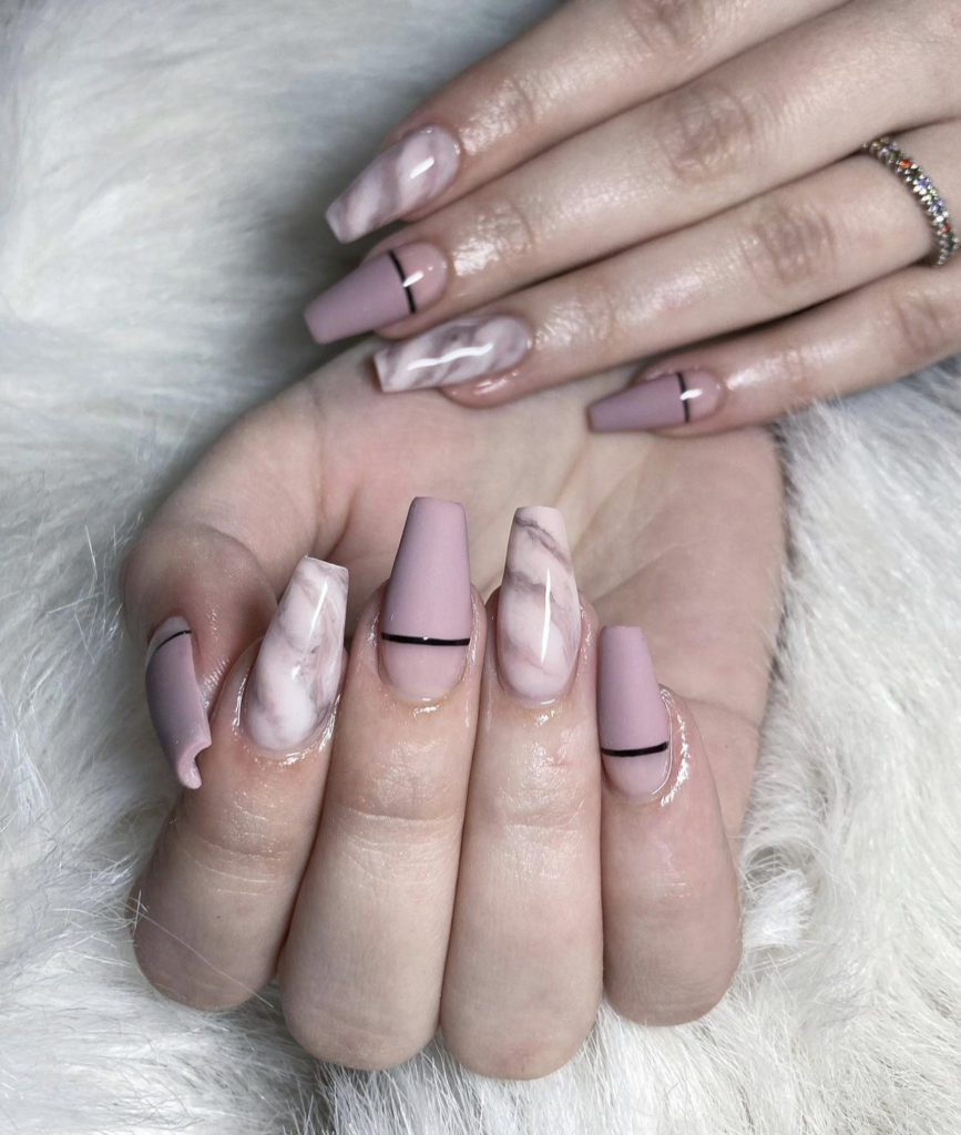 Nude marble coffin nails with black strips.