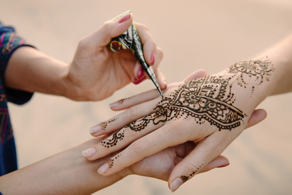 Applying henna
