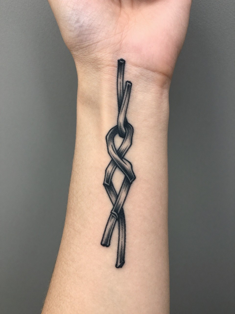 knot tattoo on a wrist. 