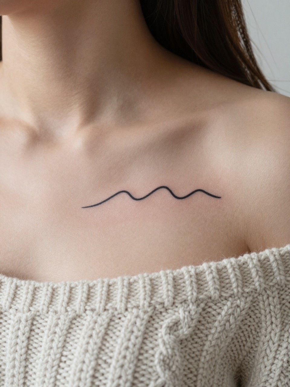 "Macro shot of a minimalist wave tattoo on the middle chest. The few simple lines of the wave are crisp against the skin. She is wearing a soft, chunky cable-knit sweater. The light is soft and diffused, creating a calm and cozy mood."