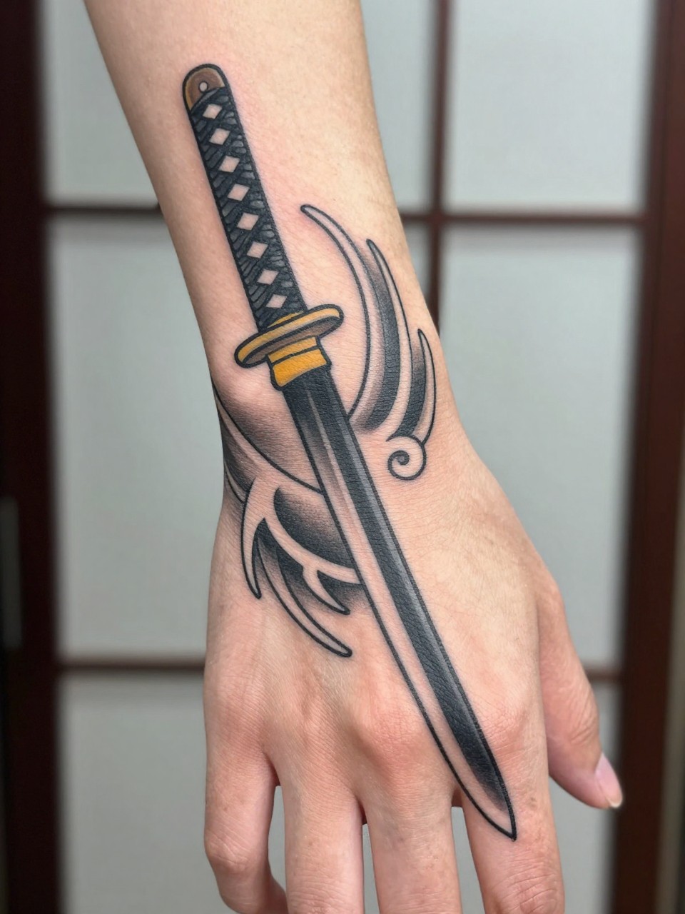 design-focused close-up of a traditional Japanese katana tattoo across the hand with wind bar details, black and grey ink, clean blade shape, bold traditional linework, soft shading, realistic skin texture, minimal blurred background, modern tattoo inspiration photo (no watermarks on images)