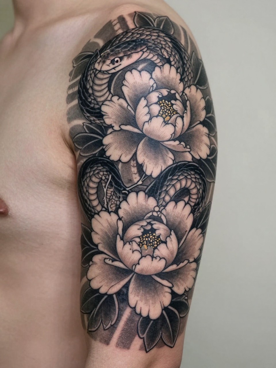 macro shot of a traditional Japanese snake and peony tattoo on the arm, coiled snake body through blooming peonies, bold black and grey ink, fine floral detail, strong traditional linework, realistic skin texture, design-first tattoo image, soft neutral background, tattoo inspiration image (no watermarks on images)