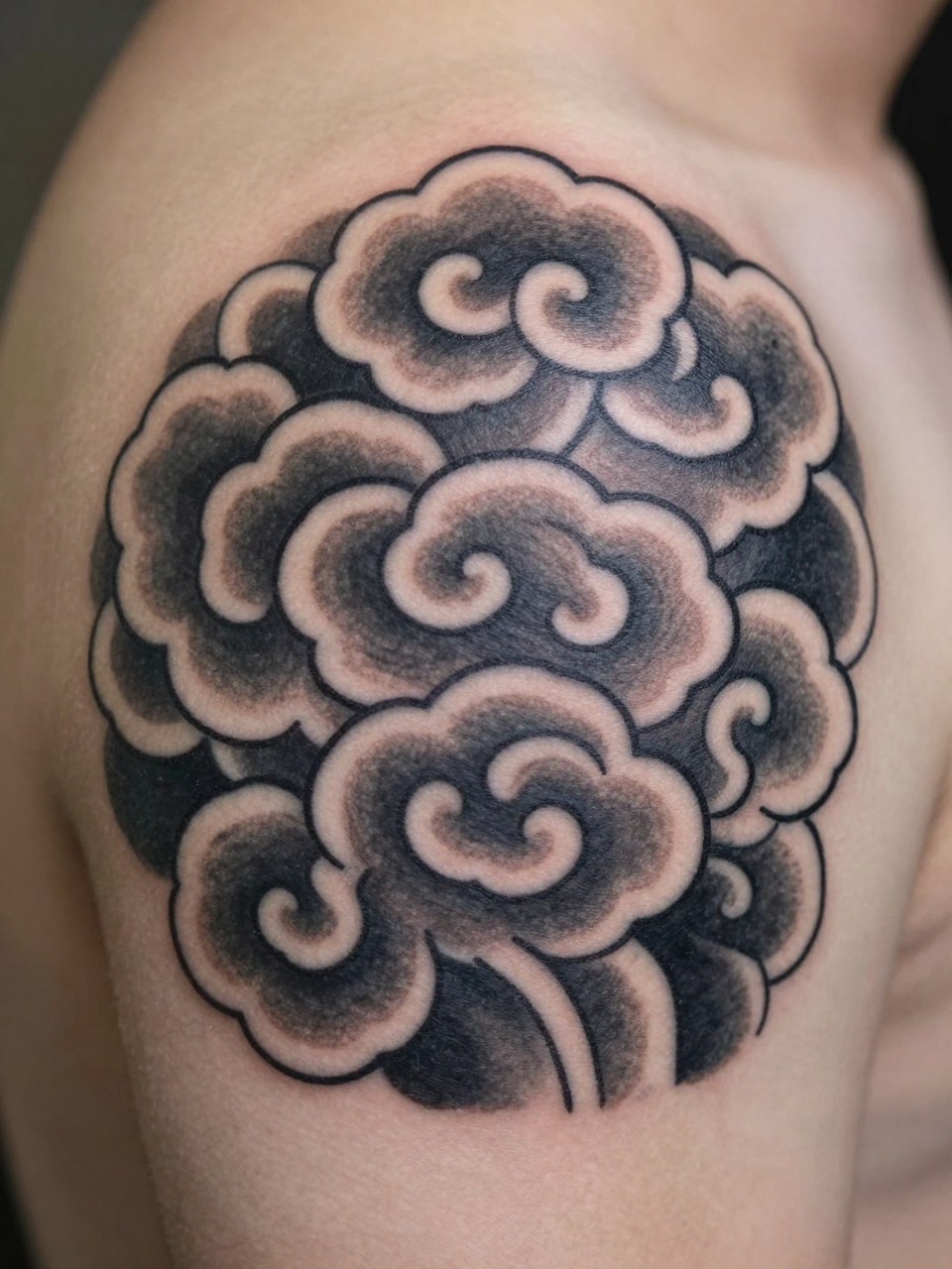 macro shot of a Japanese cloud tattoo on the side of the neck, bold traditional cloud forms, black and grey ink, crisp linework, soft shading, realistic skin texture, design-first tattoo image, soft neutral background, tattoo inspiration image (no watermarks on images)