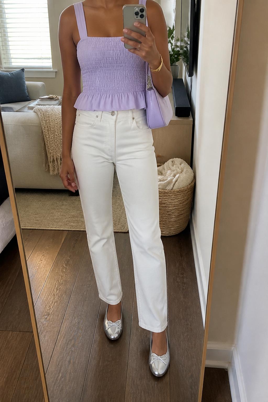 IMAGE_PROMPT: mirror selfie of a black woman wearing a lavender smocked square-neck top, white straight-leg jeans, silver ballet flats, lilac mini shoulder bag, and glossy nude lip makeup, clearly showing the same clothing items listed in the Outfit Pieces section, holding a phone in front of a mirror, cropped at the NECK so the face does not show, relaxed casual selfie pose, in a cozy living room with a leaning floor mirror, natural window light, with woven basket near the mirror, latest iPhone photo quality.