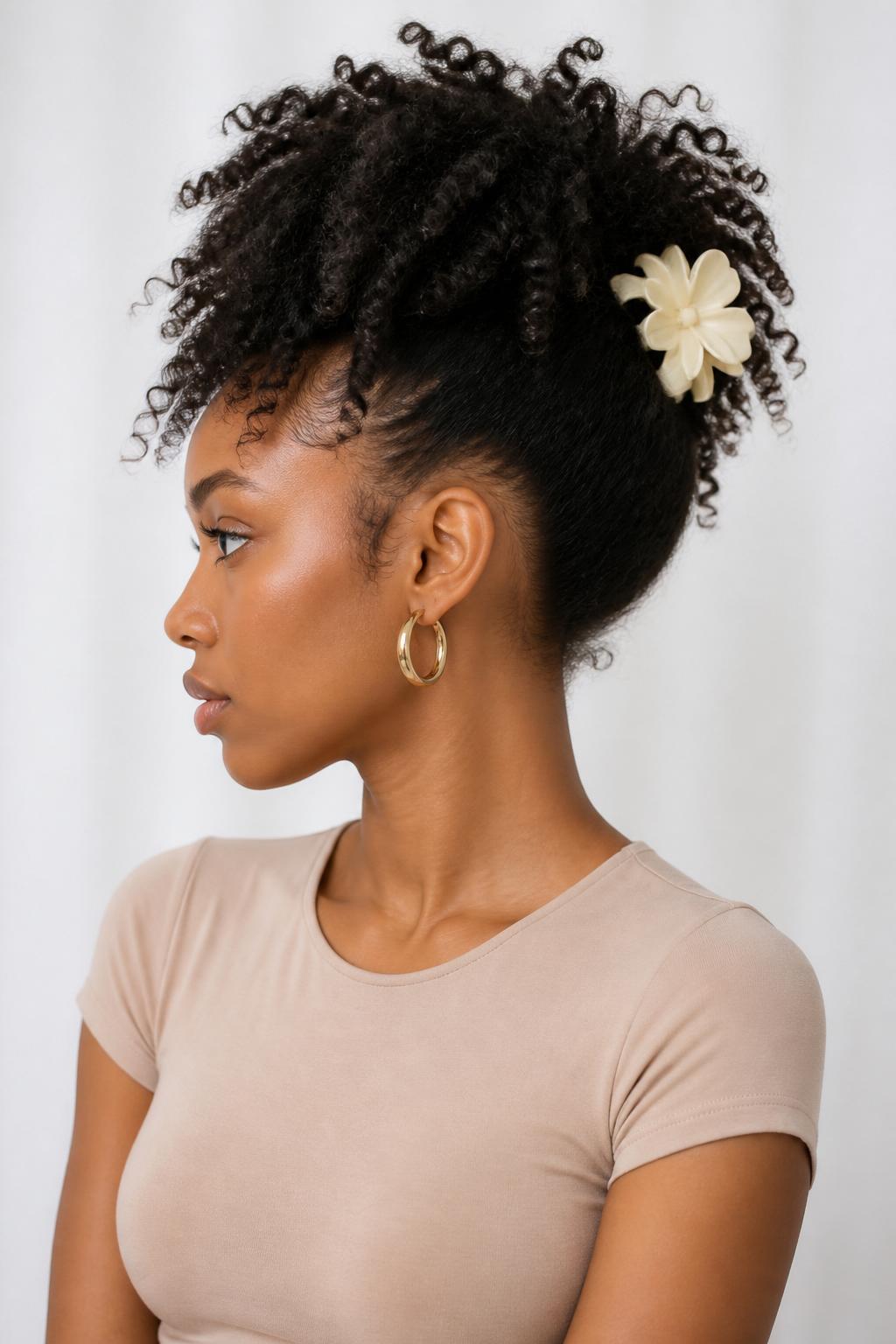 Image Prompt:
A realistic beauty portrait of a black woman with medium-long natural curly hair styled into a high curly puff secured with a large cream flower claw clip at the back, defined curls spilling upward and outward, soft edges, warm brown skin, gold hoop earrings, fitted beige top, clean bright studio background, natural texture hairstyle inspiration, high-resolution DSLR photo, no text, (no watermarks on images)