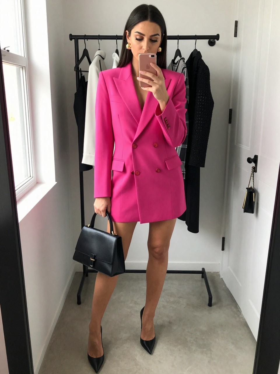 Image Prompt

mirror selfie of a woman wearing a fuchsia tailored blazer mini dress, black pointed-toe pumps, gold dome earrings, black structured top-handle bag, and sleek straight hair with defined eyeliner, clearly showing the same clothing items, colors, fabrics, and accessories listed in the Outfit Pieces section, holding a phone in front of a mirror, cropped at NECK so the face does not show, with a relaxed casual selfie pose, in a fashion studio mirror corner, natural window light, including a clothing rack with garments behind and a handbag hanging on a door handle, latest iPhone photo quality.