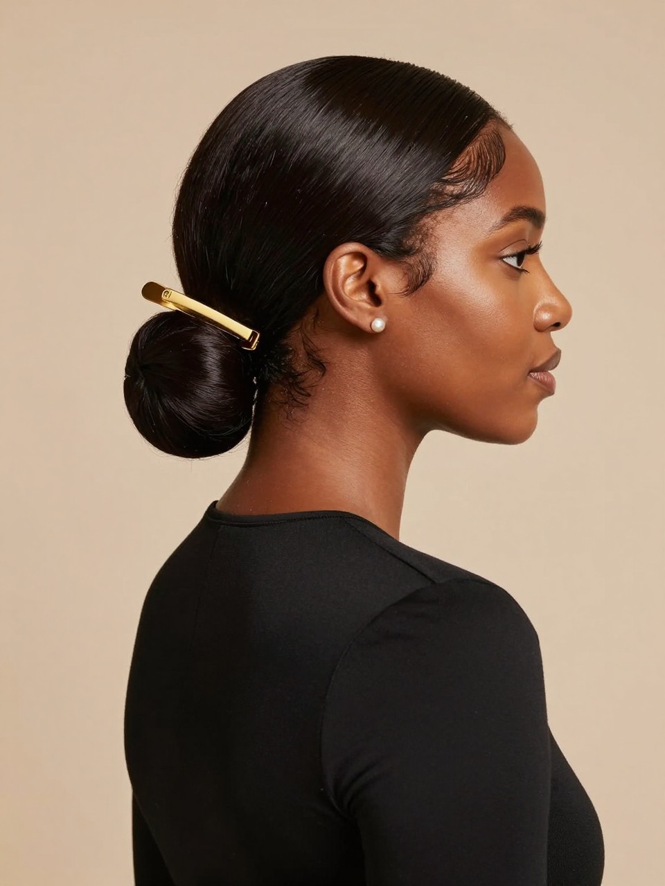 Image Prompt:
A realistic editorial hairstyle photo of a black woman with medium-long silk-pressed hair styled in a smooth low tuck, ends folded gently under and secured with a long gold flat hair clip at the nape, clean side part, glossy finish, warm brown skin, pearl studs, fitted black top, beige studio background, polished modern hairstyle inspiration, high-resolution DSLR photo, no text, (no watermarks on images)