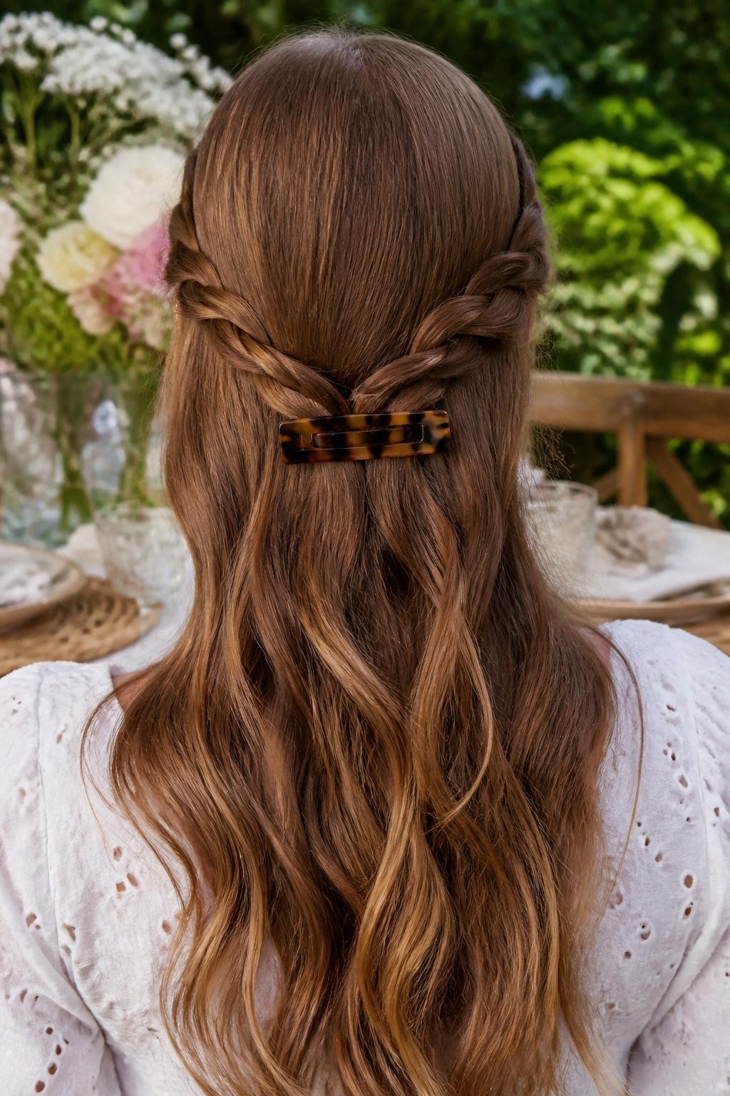 Image Prompt:
A realistic close-up back-view hairstyle photo of a woman with long light brown hair styled half-up with two thin side braids meeting at the back, braids secured with a rectangular tortoiseshell flat hair clip, loose soft waves flowing down, white eyelet blouse, outdoor garden table background, warm natural light, romantic braided hairstyle inspiration, high-resolution DSLR photography, no text, (no watermarks on images)