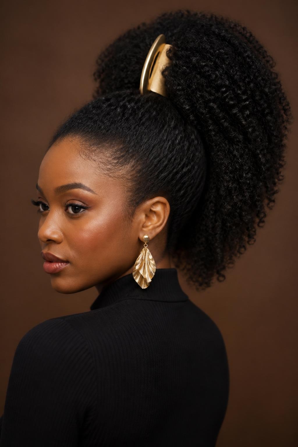 Image Prompt:
A realistic portrait of a black woman with long coily natural hair styled into a high banana clip ponytail, hair gathered upward with a matte gold banana clip, full textured ponytail shape, soft edges, warm brown skin, statement earrings, fitted black top, warm studio lighting, bold natural hairstyle inspiration, high-resolution DSLR photo, no text, (no watermarks on images)