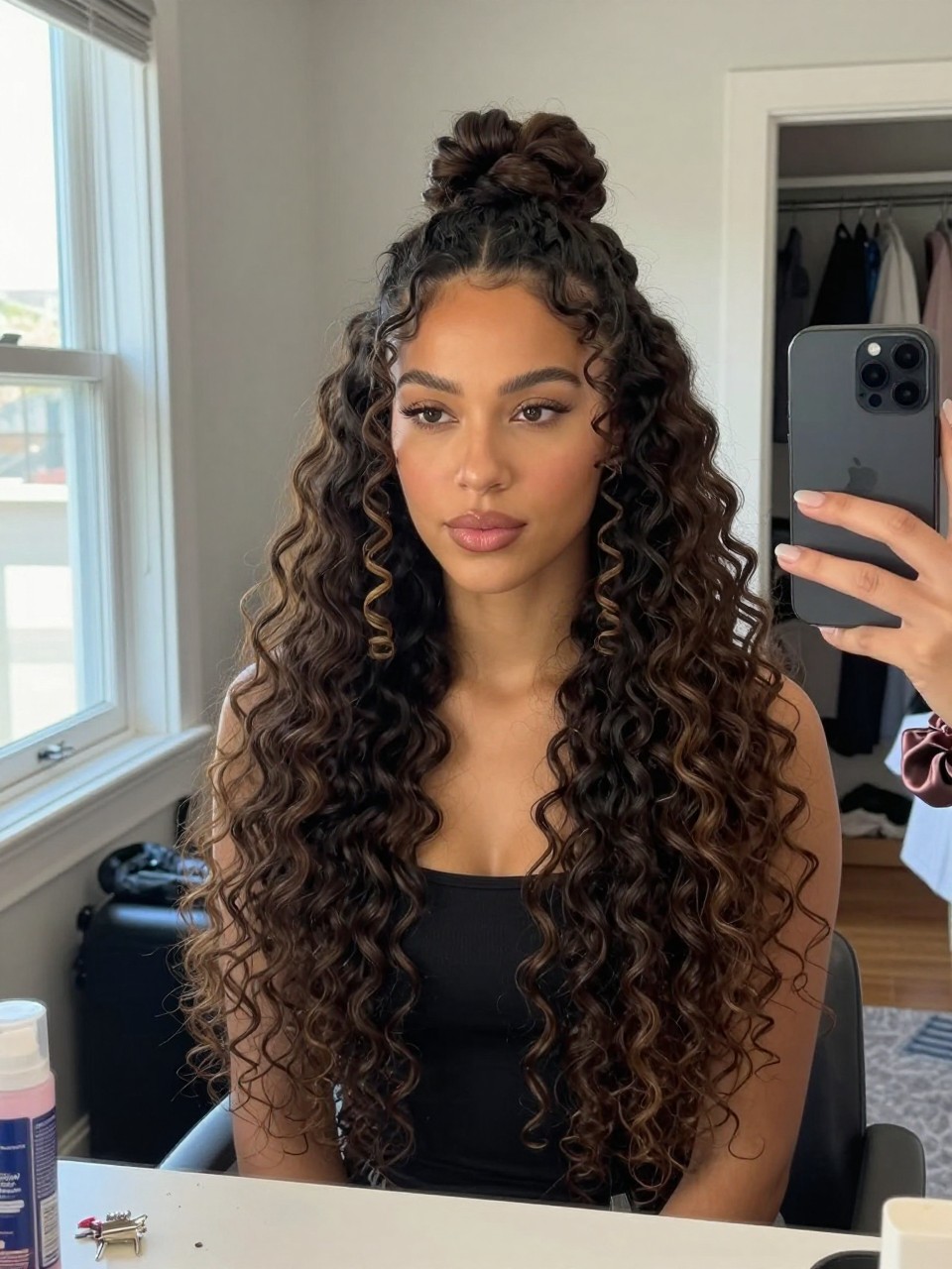 Image prompt

Photo of a Latina woman wearing long 4A curls in a half-up bun with a soft rounded shape at the crown, full defined coils cascading below, and two spiral tendrils framing the face, candid bedroom mirror selfie, natural window light, containing a small lived-in detail such as bobby pins and a curl refresher bottle on the dresser, a silk scrunchie on her wrist, and a slightly open closet behind her, realistic getting-ready moment, latest iPhone photo quality.