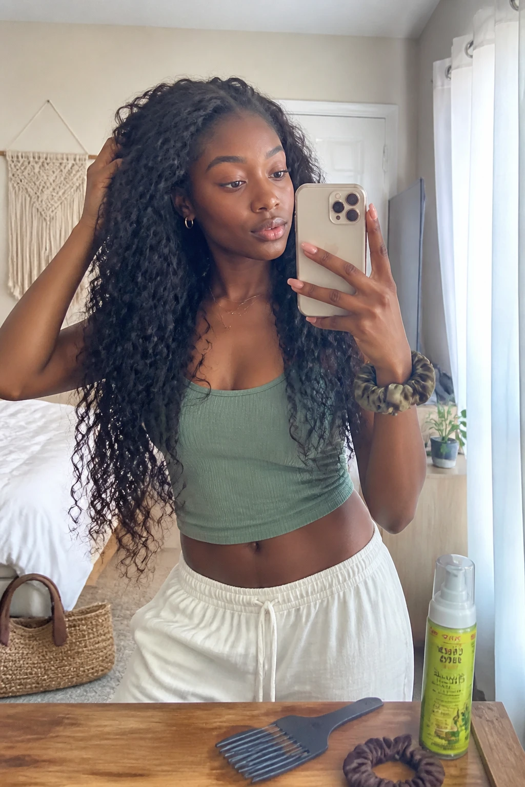 Image prompt
Photo of a Black woman wearing waist-length bohemian curly sew-in hair with a mixture of loose spirals, soft waves, and slightly undone textured pieces, candid mirror selfie in a bright bedroom, natural window light, containing a small lived-in detail such as curl mousse and a wide-tooth comb on the dresser, a woven handbag near the bed, and a silk scrunchie on her wrist, realistic relaxed getting-ready moment, latest iPhone photo quality.