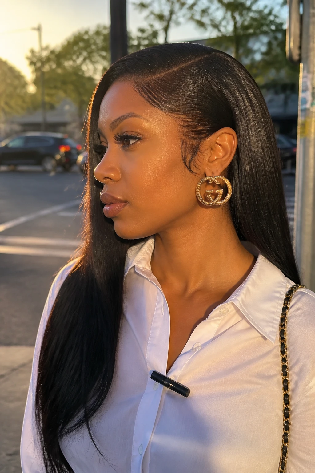 Image prompt

Photo of a woman wearing a long deep side-part straight weave with one side tucked neatly behind her ear and smooth hair falling over the opposite shoulder, side profile view highlighting the part and statement earring, softly blurred city street background, golden hour glow, containing a small lived-in detail such as a slim hair clip attached to her collar, realistic candid moment, latest iPhone photo quality.
